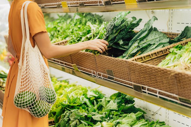 women looking at fresh greens in a supermarket