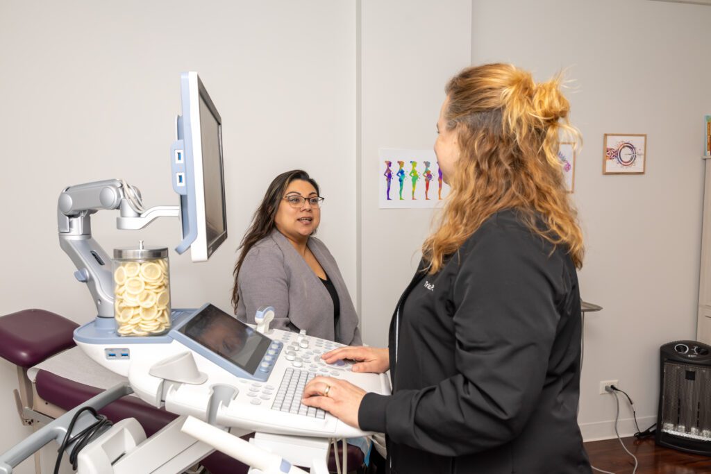 Sonographer talking with patient