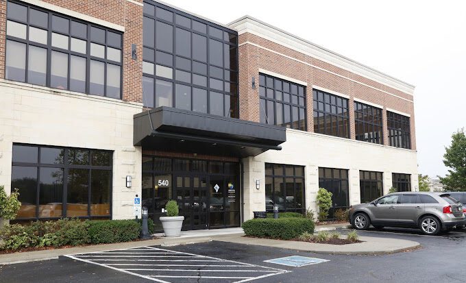 A modern fertility clinic office with large windows and a welcoming entrance, symbolizing hope and expert care for patients on their journey.