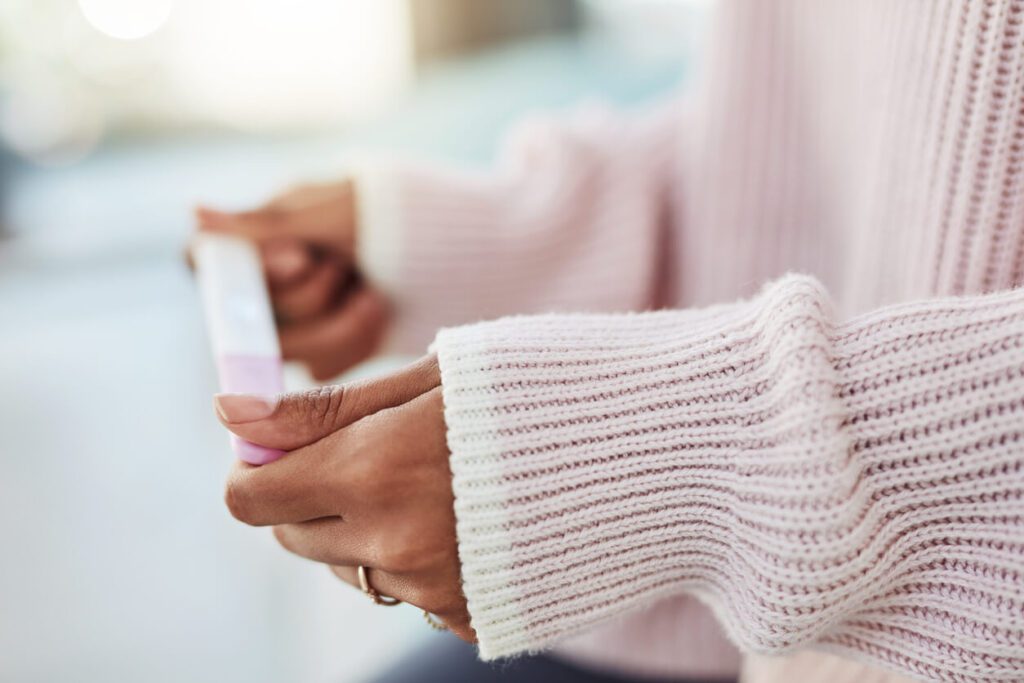 woman looking at a pregnancy test