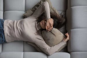 photo of a tired female experiencing endometriosis symptoms