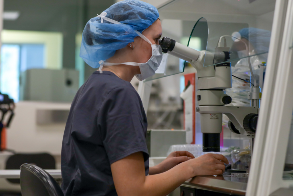 Woman looking into microscope