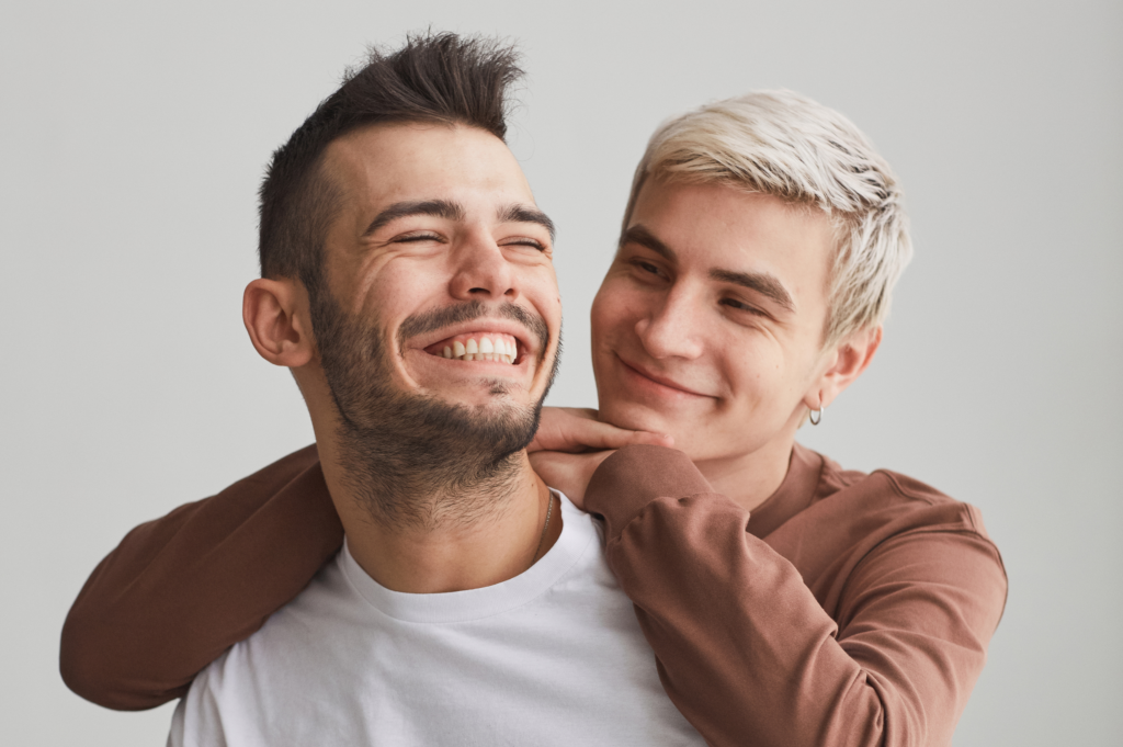 A heartfelt moment of love and joy, as one partner embraces the other from behind, radiating warmth and affection.