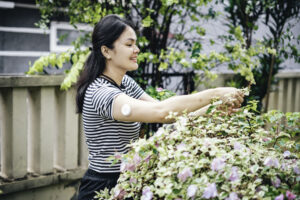 Day in the life of woman with cgm examining flowers in green house