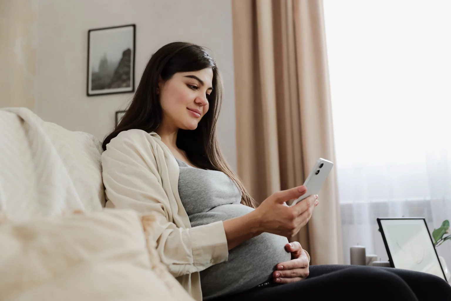 Pregnant woman looking on her phone