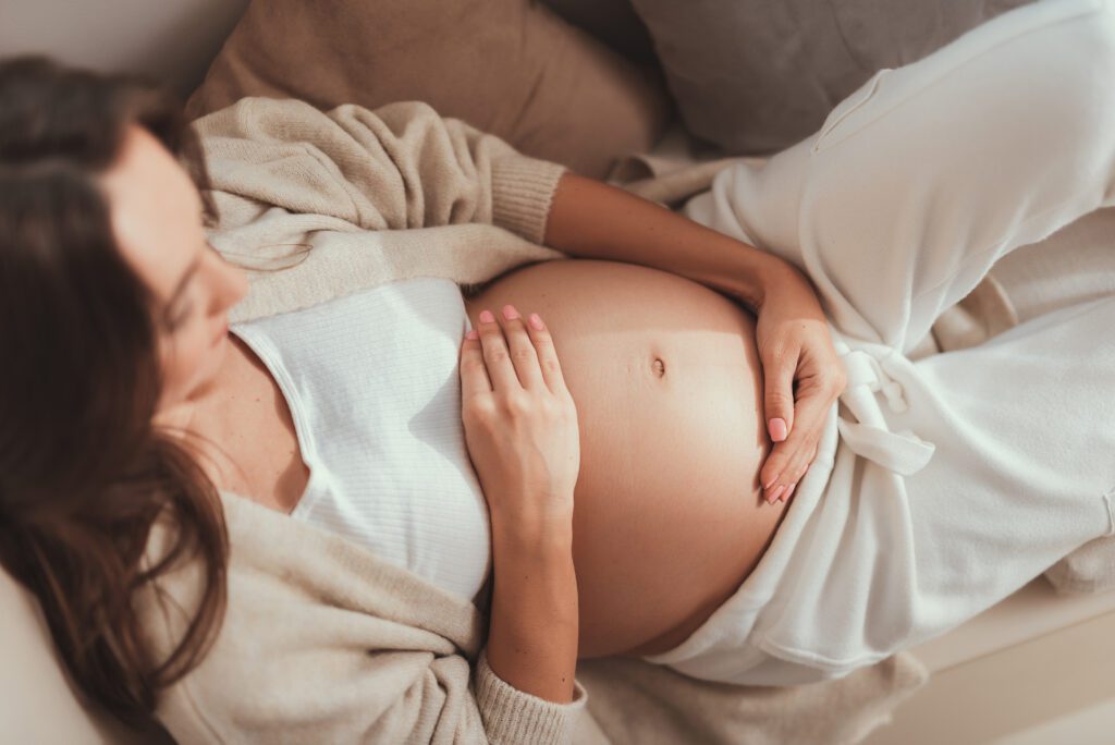 Mother rubbing her pregnant belly