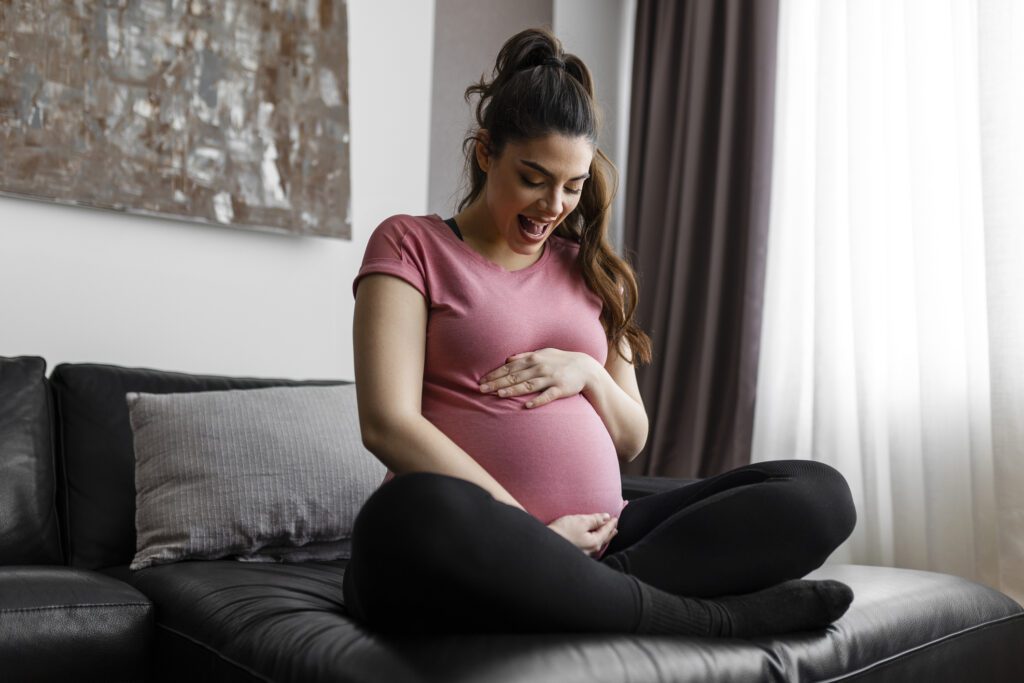 Healthy pregnancy. Side view pregnant woman with big belly advanced pregnancy. Elegant mother waiting baby