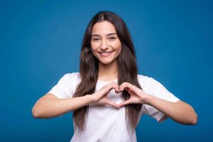 woman making heart sign with hands