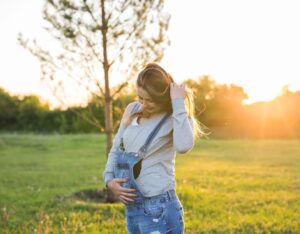 young happy pregnant woman in nature