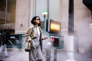 Stylish businesswoman walking near Wall Street subway station in New York City