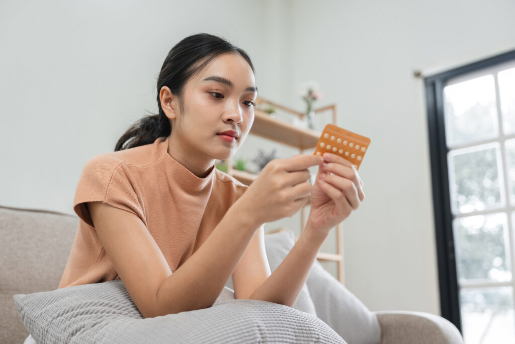 Woman Taking Birth Control Pills at Home, Focused on Contraceptive Health and Family Planning, Modern Lifestyle and Healthcare Concept